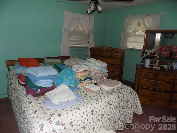 a bedroom with bed and a window