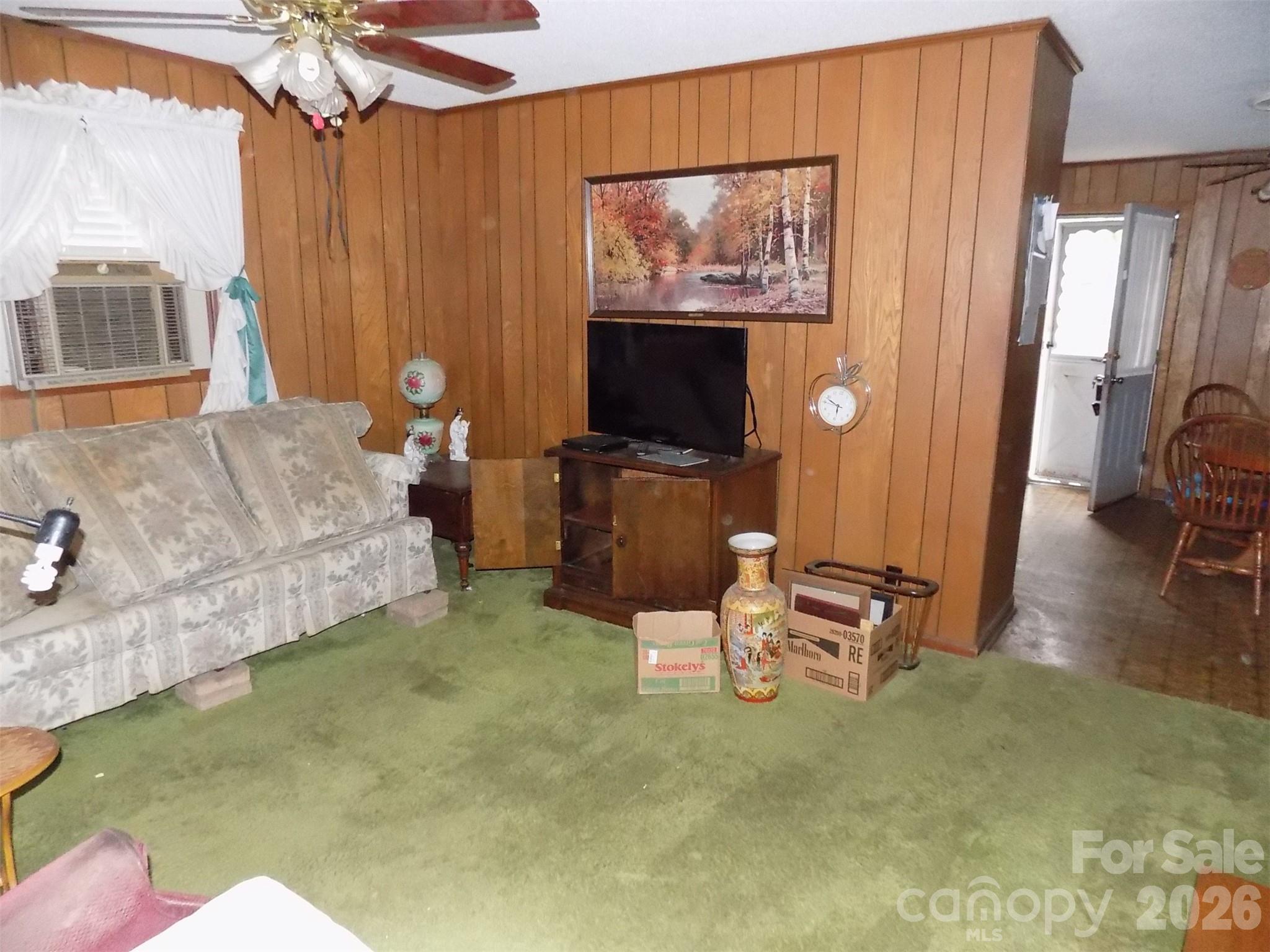 2605 Lowell Road Gastonia, NC 28054 - Photo 4 of 21 a living room with furniture and a flat screen tv