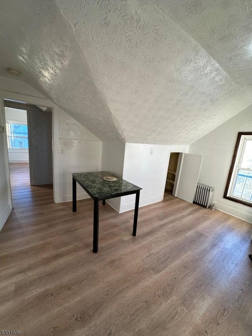 421 Ellison Street Paterson, NJ 07501 - Photo 12 of 12 a living room with furniture and a wooden floor