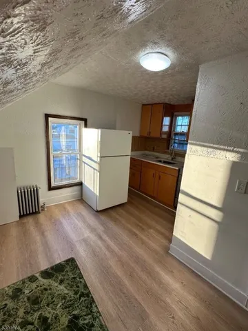 a view of kitchen with furniture and wooden floor
