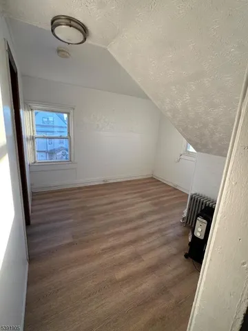 a view of room with window and hardwood floor