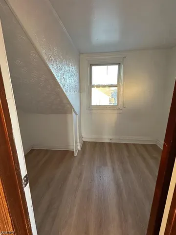 a view of an empty room and wooden floor
