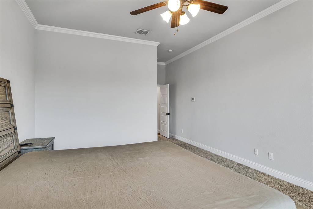 1306 Elizabeth Street Anna, TX 75409 - Photo 28 of 36 Unfurnished bedroom with a ceiling fan, ornamental molding, and carpet