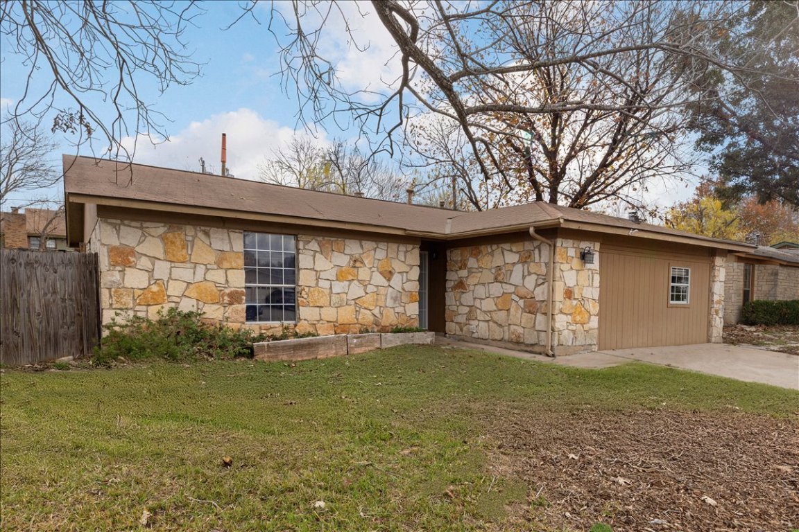 View of side of home featuring stone siding