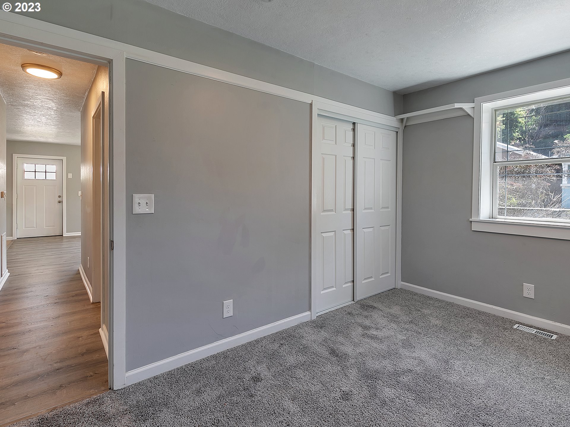 201 Southwest Hailey Avenue Pendleton, OR 97801 - Photo 19 of 35 a view of an empty room with wooden floor and a window