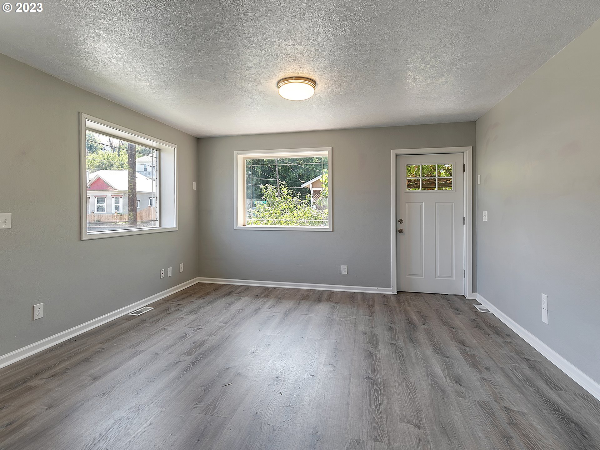 201 Southwest Hailey Avenue Pendleton, OR 97801 - Photo 6 of 35 a view of an empty room with wooden floor and a window