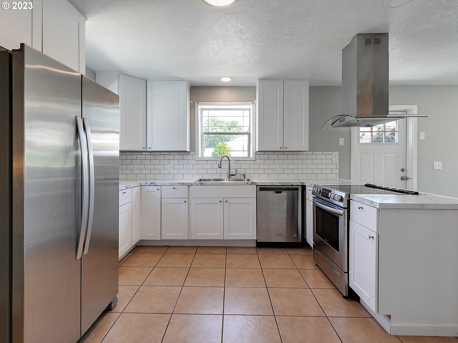 201 Southwest Hailey Avenue Pendleton, OR 97801 - Photo 7 of 35 a kitchen with stainless steel appliances granite countertop a stove a sink and a refrigerator