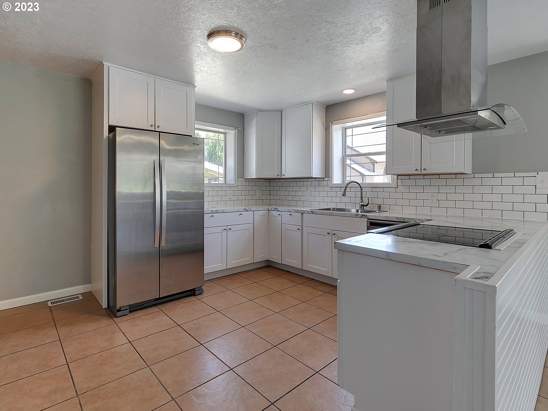201 Southwest Hailey Avenue Pendleton, OR 97801 - Photo 9 of 35 a kitchen with a sink a refrigerator and cabinets