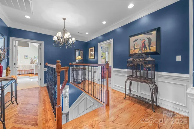 a view of a livingroom with furniture wooden floor chandelier and a chandelier