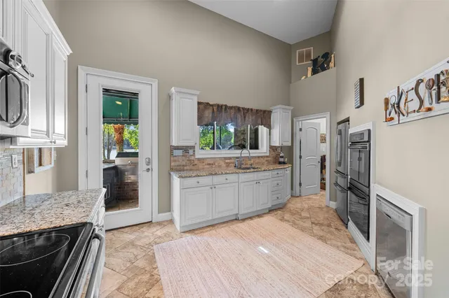 a view of patio with table and chairs under an umbrella