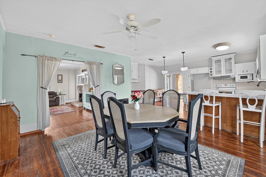 304 East Main Street Itasca, TX 76055 - Photo 9 of 38 Wood-finish flooring extends throughout, complemented by a ceiling fan with integrated lighting