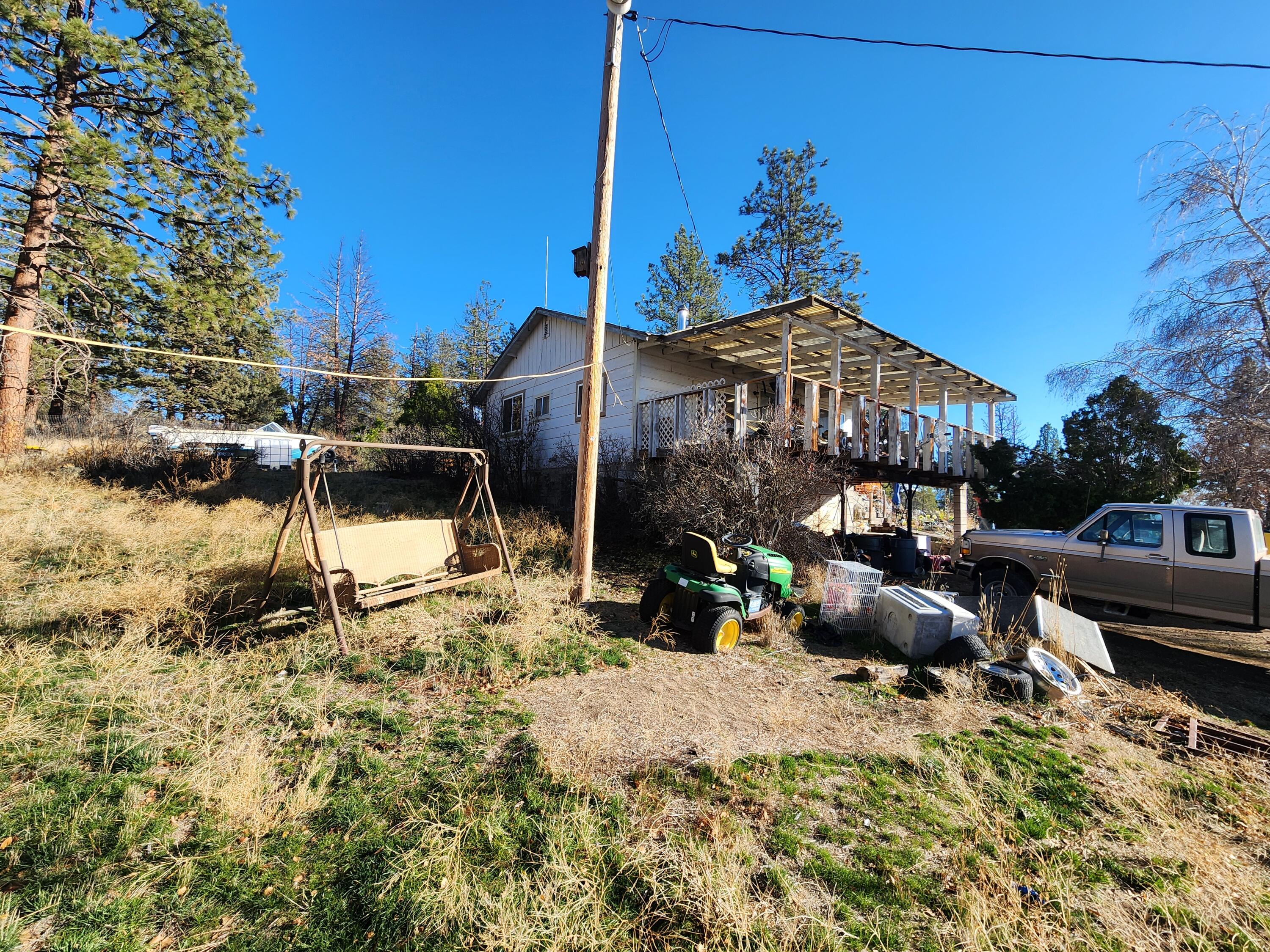 29151 Beatty Drive Beatty, OR 97621 - Photo 9 of 16 a view of a patio with a table and chairs under an umbrella
