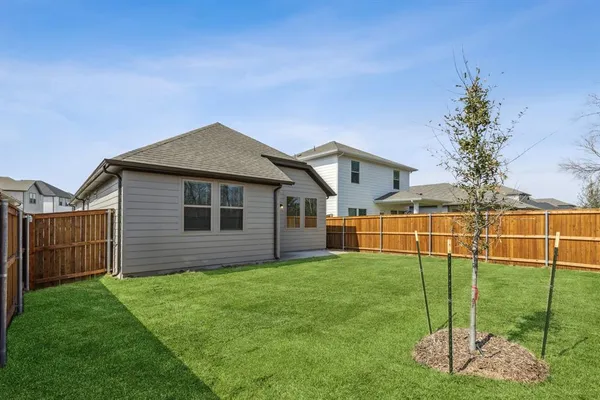 a view of a house with a yard and deck