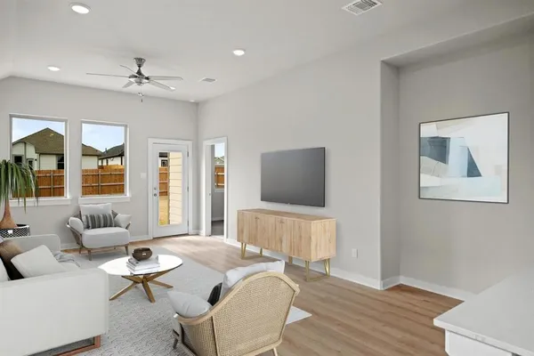 a living room with furniture and a flat screen tv