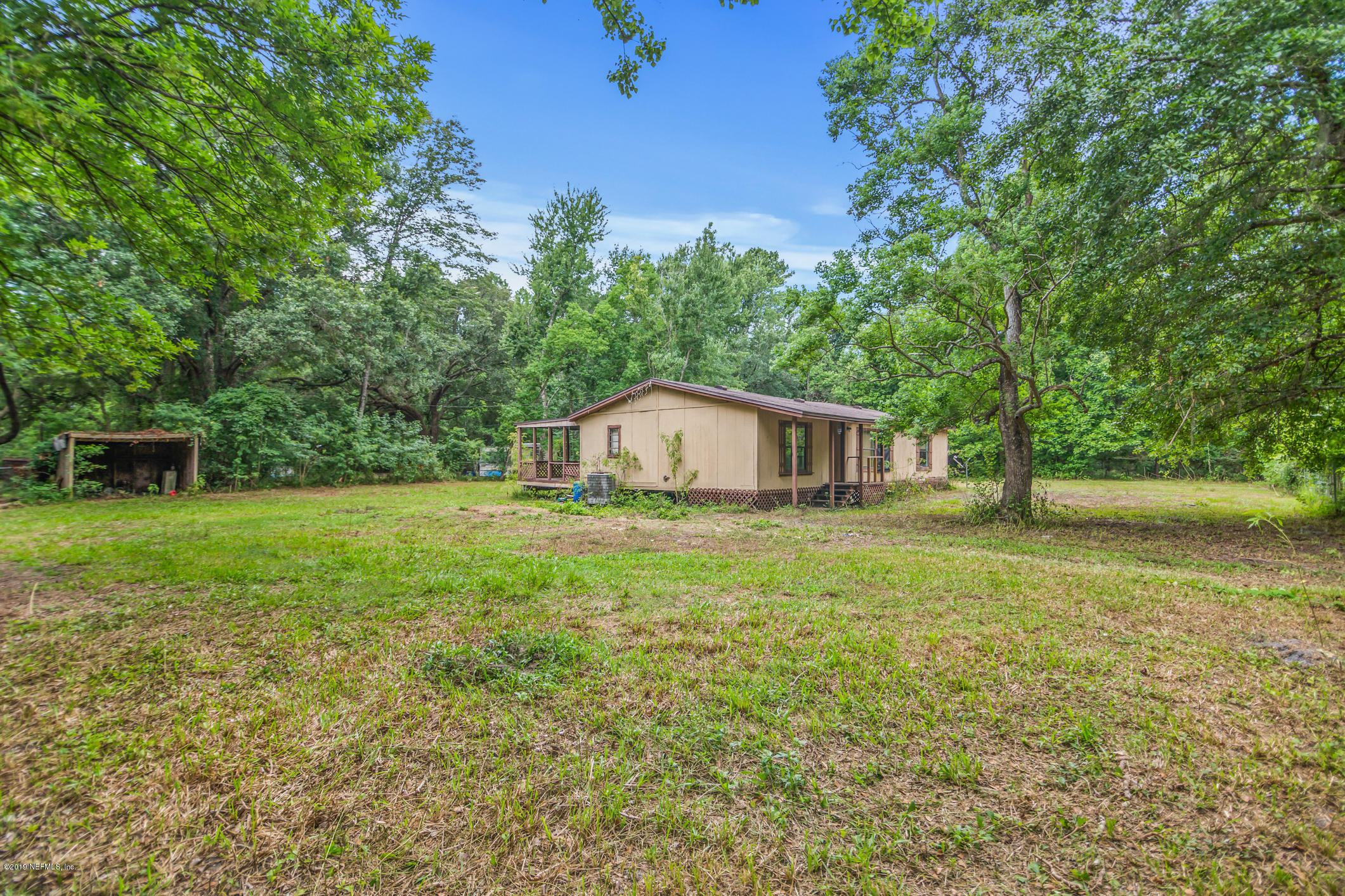 135 Buckner Road Middleburg, FL 32068 - Photo 4 of 27 a backyard of a house with lots of green space
