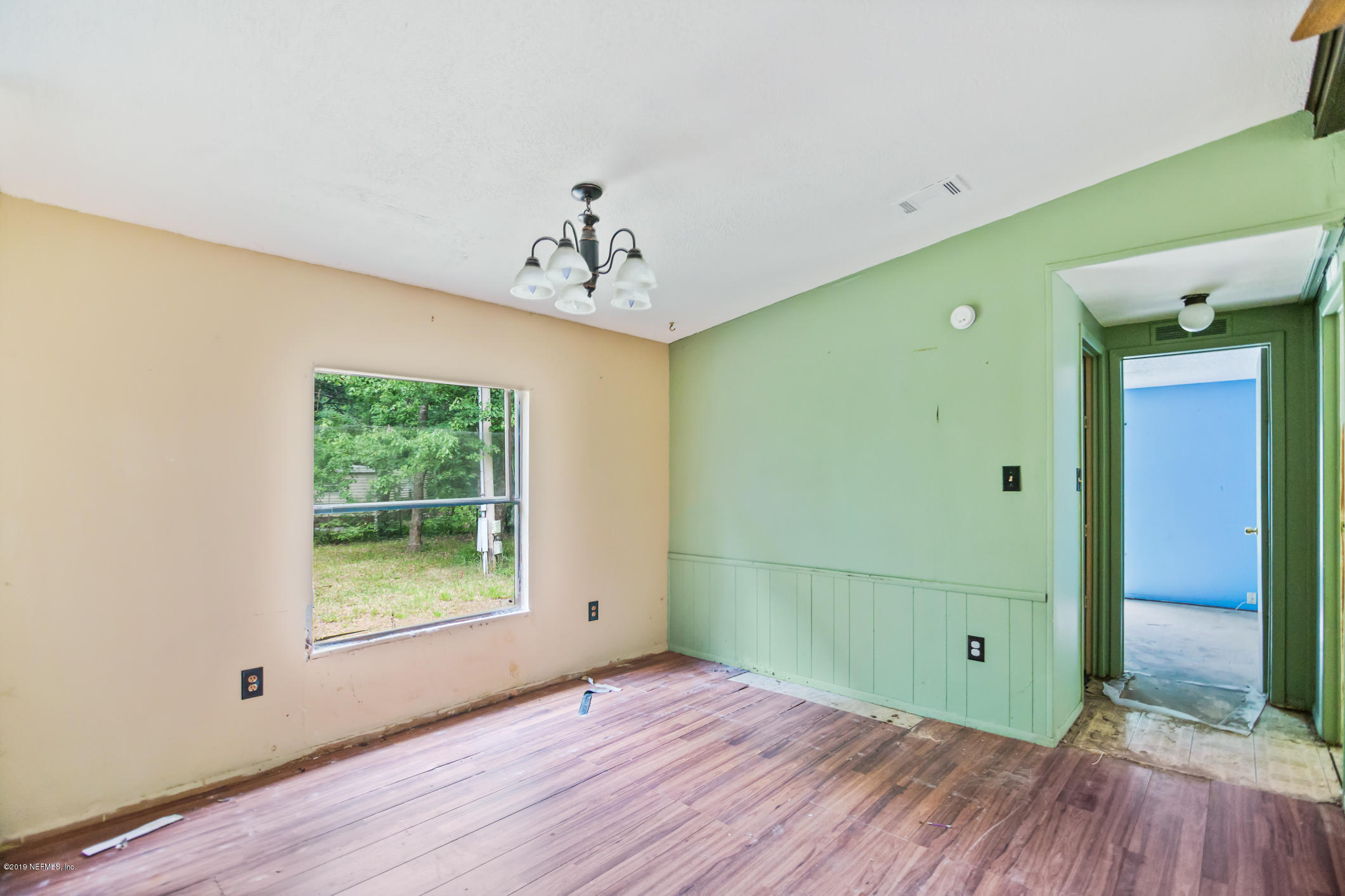135 Buckner Road Middleburg, FL 32068 - Photo 8 of 27 a view of a room with wooden floor and windows