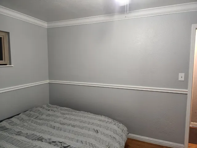 a bathroom with a granite countertop shower and a toilet