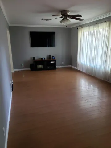 a view of a livingroom with furniture and a ceiling fan