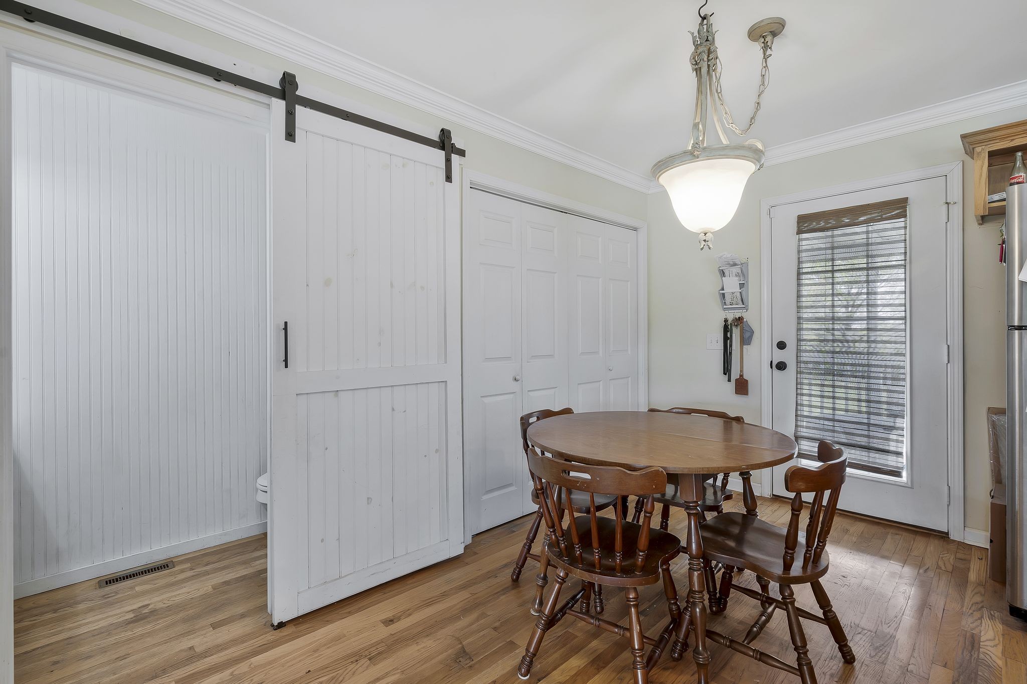 980 Hoover Road Burns, TN 37029 - Photo 11 of 33 a view of a dining room with furniture window and wooden floor