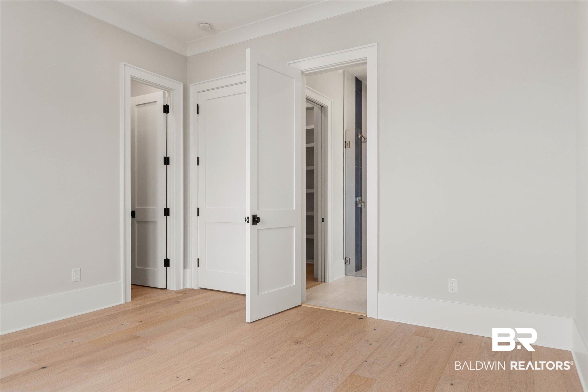 853 Inlet Circle Gulf Shores, AL 36542 - Photo 32 of 55 Unfurnished bedroom featuring baseboards and light wood-type flooring