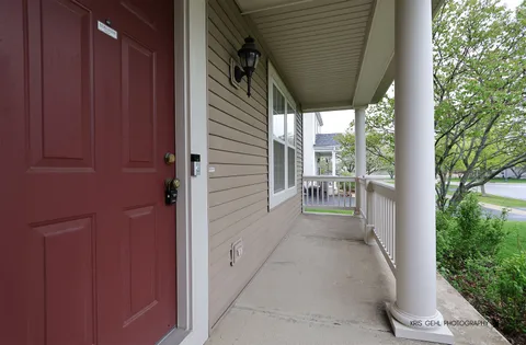 a view of a porch with wooden floor and stairs