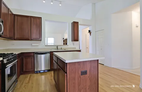 a kitchen with a sink stove top oven and cabinets