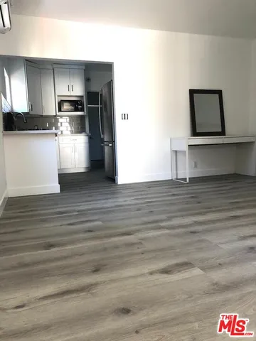 a view of kitchen with wooden floor and electronic appliances