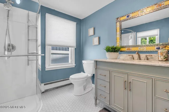 a bathroom with a sink a toilet and mirror