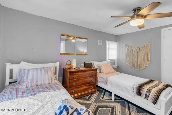 a bedroom with furniture and wooden floor