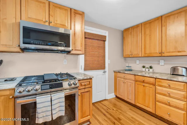 a kitchen with stainless steel appliances a stove a microwave sink and cabinets
