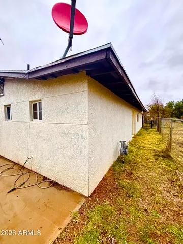 a front view of house along with trees