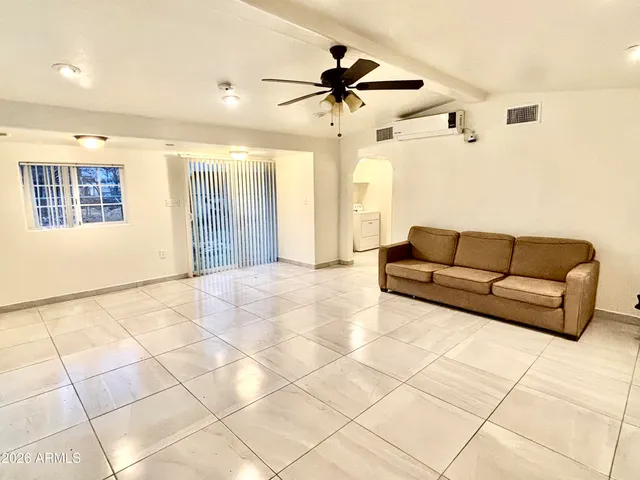 a living room with a black white checkered floor