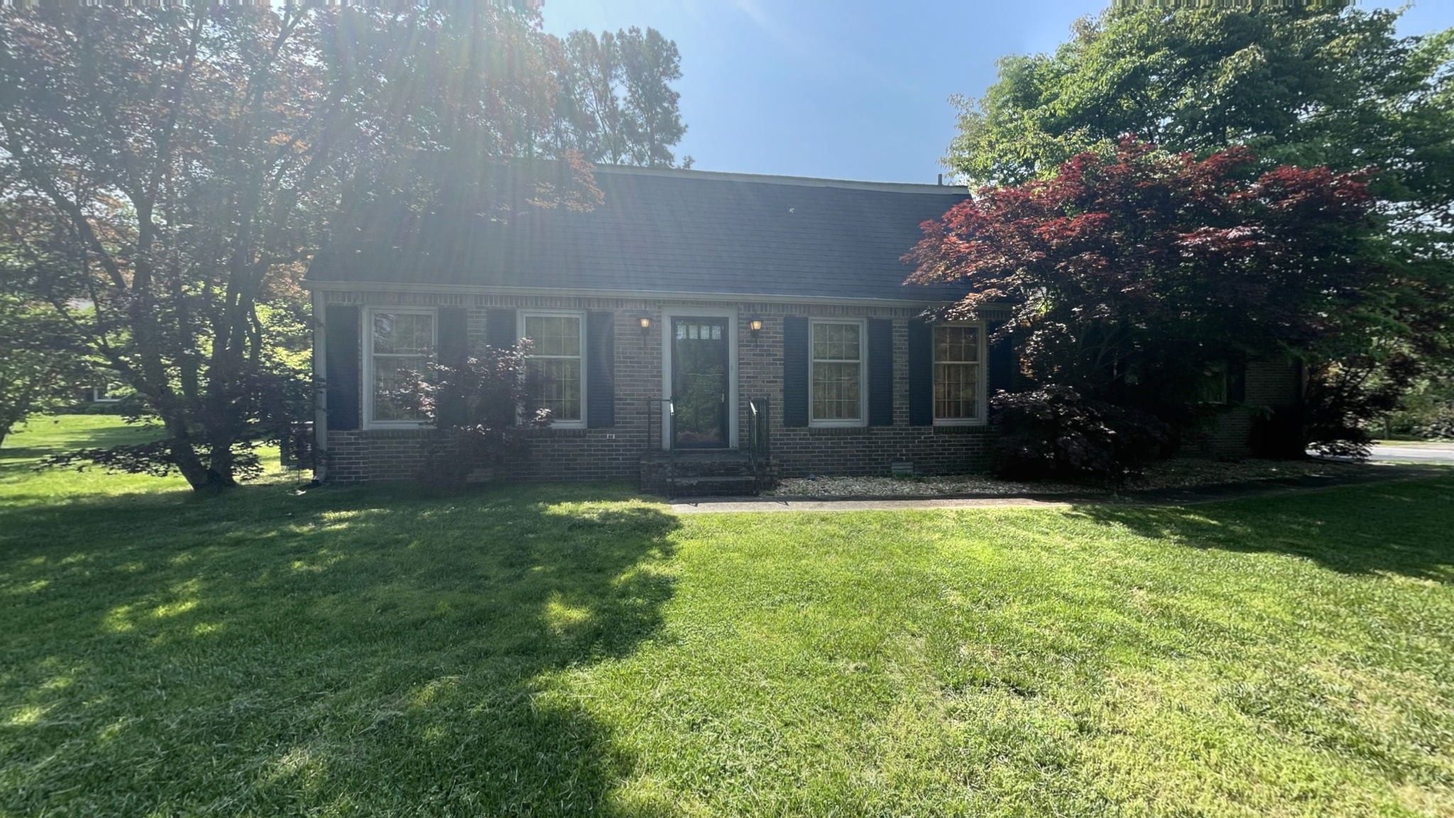 a view of house with yard