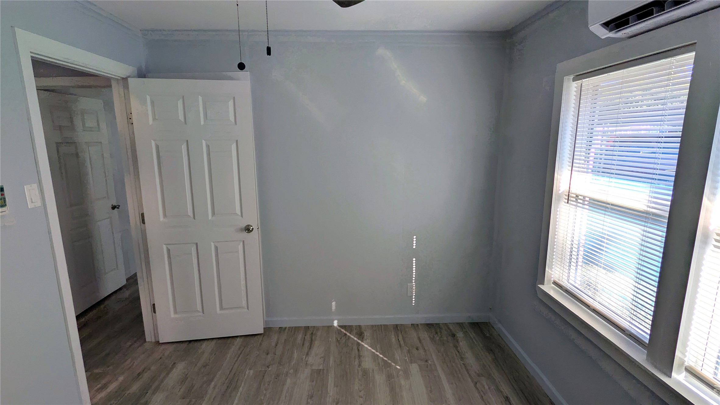4122 Botany Lane Houston, TX 77047 - Photo 12 of 24 a view of a room with wooden floor and sliding window