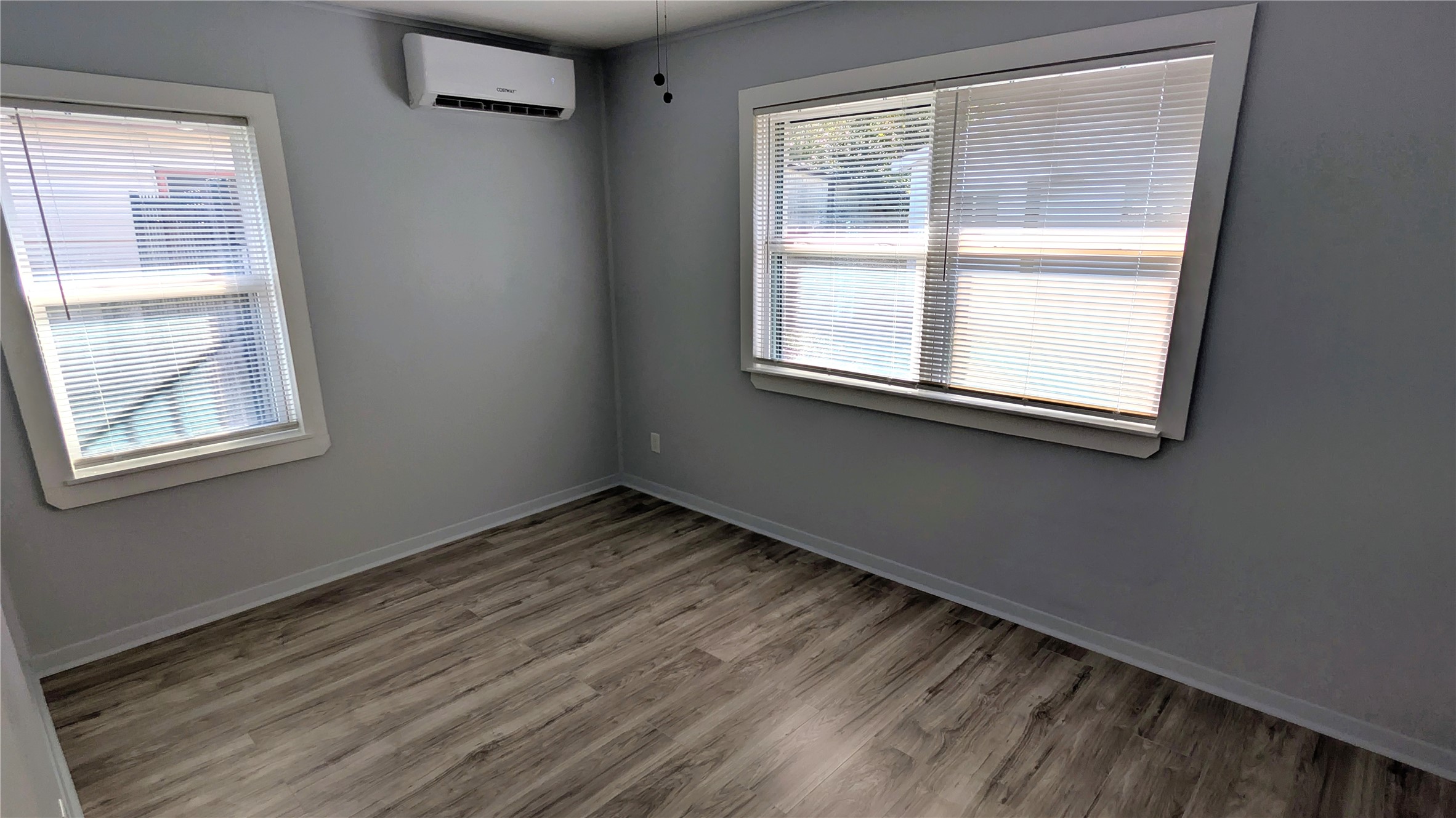 4122 Botany Lane Houston, TX 77047 - Photo 13 of 24 a view of an empty room with wooden floor and a window