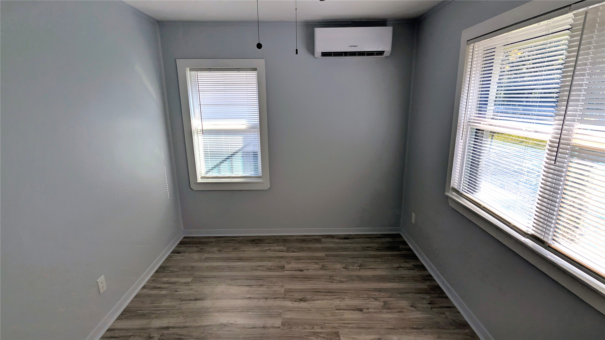 4122 Botany Lane Houston, TX 77047 - Photo 14 of 24 en empty room with wooden floor and windows