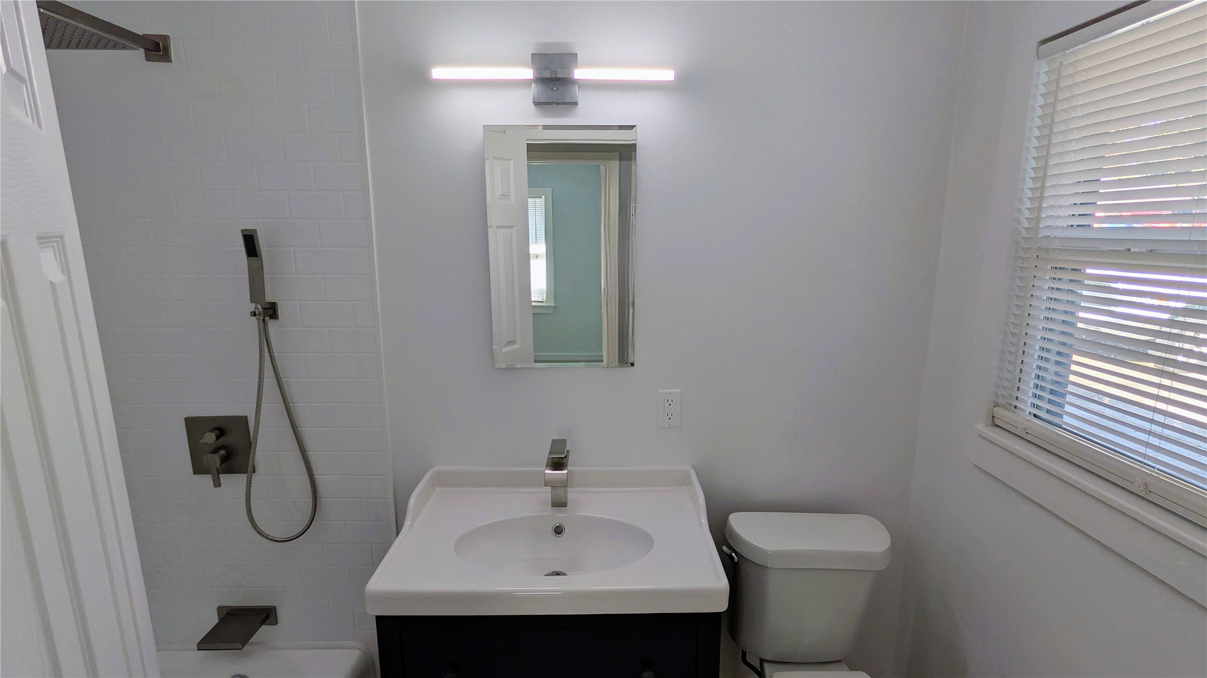 4122 Botany Lane Houston, TX 77047 - Photo 15 of 24 a bathroom with a toilet sink and mirror