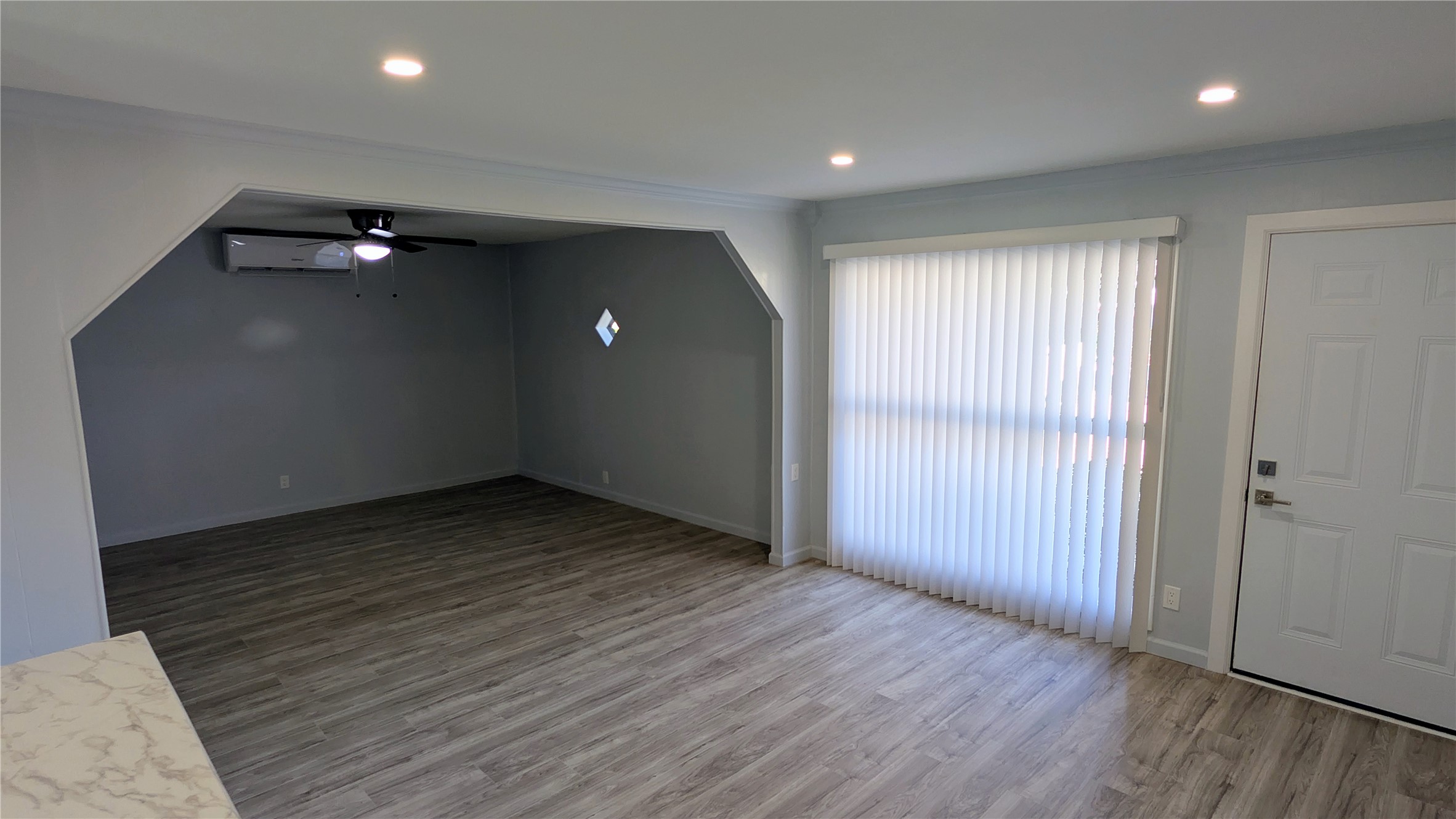4122 Botany Lane Houston, TX 77047 - Photo 3 of 24 an empty room with wooden floor and windows