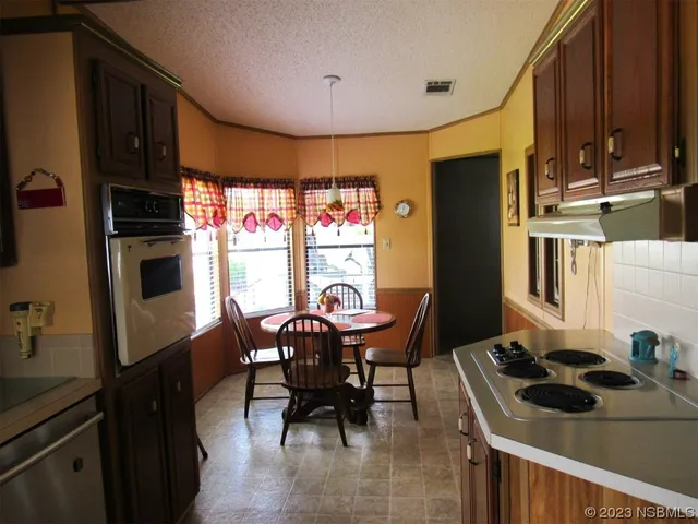 a kitchen with a table and chairs in it