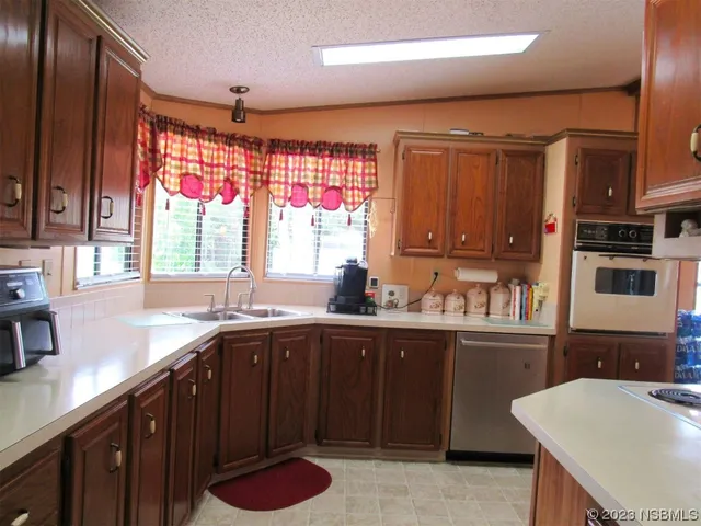 a kitchen with a sink a window and cabinets