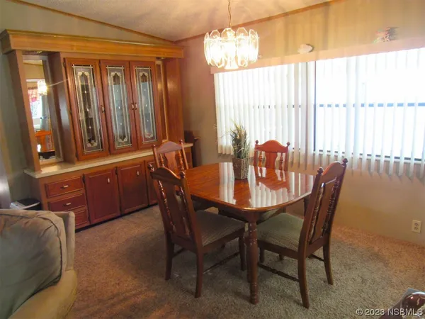 a dining room with furniture and window