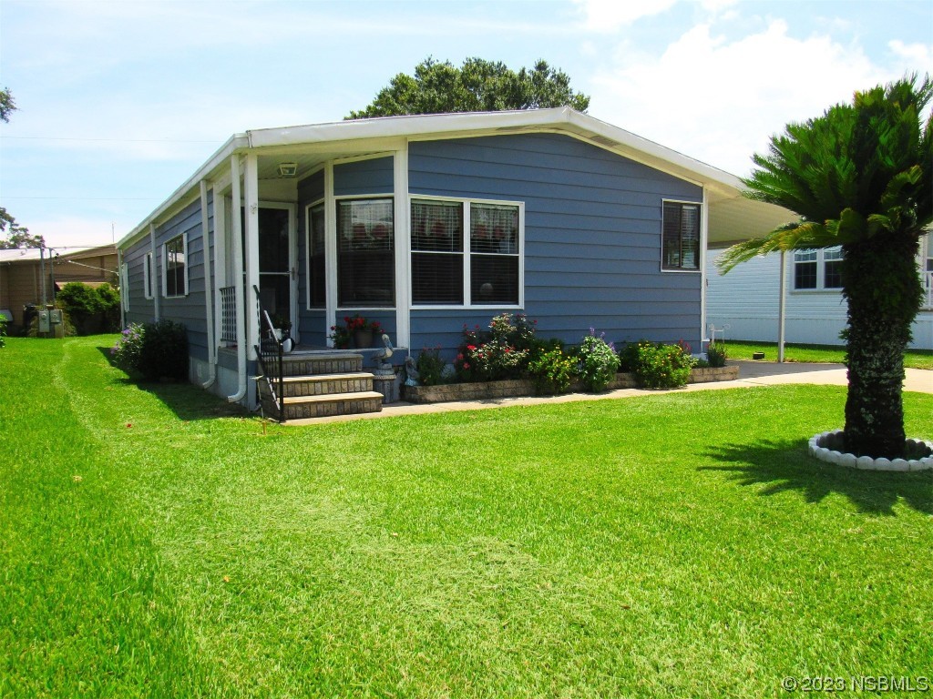 4347 Cedar Way Edgewater, FL 32141 - Photo 2 of 32 a front view of a house with garden