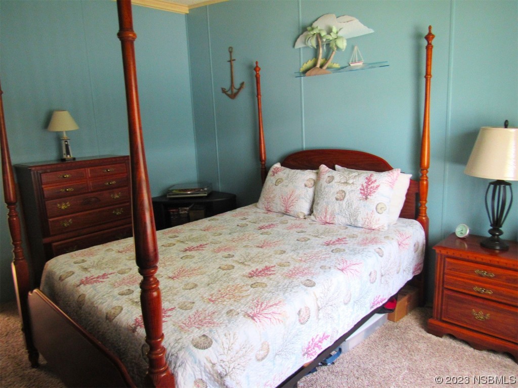 4347 Cedar Way Edgewater, FL 32141 - Photo 25 of 32 a bedroom with a bed and a chandelier