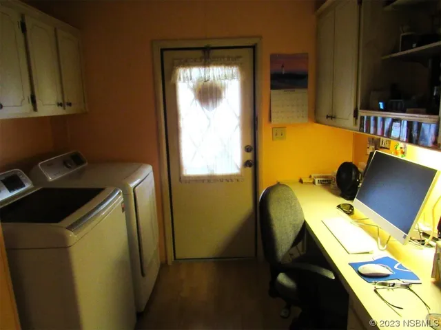 a bed room with a desk chair and a window