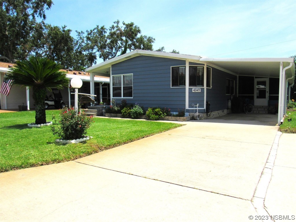 4347 Cedar Way Edgewater, FL 32141 - Photo 31 of 32 a house view with a garden space