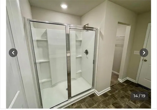 a bathroom with a glass shower door