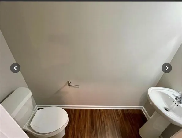a white toilet sitting next to a bathroom sink