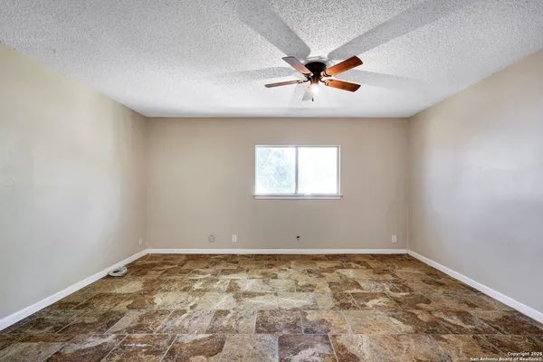 a view of a ceiling fan and window