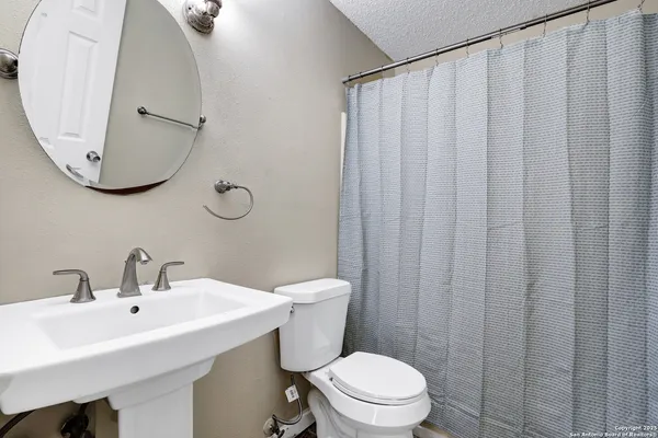 an empty room with a window and a ceiling fan