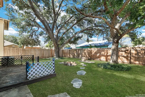 a backyard of a house with lots of green space and lake view